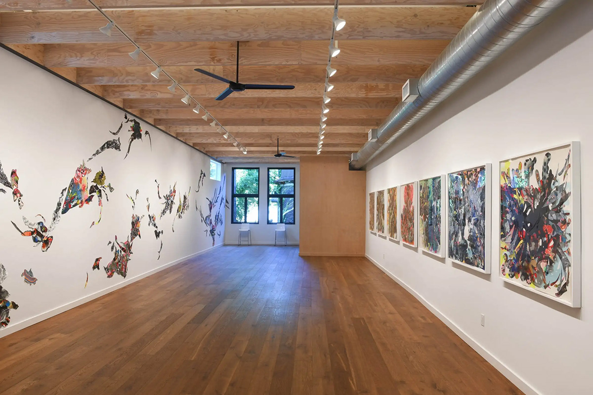 An open gallery space with paintings on the walls
