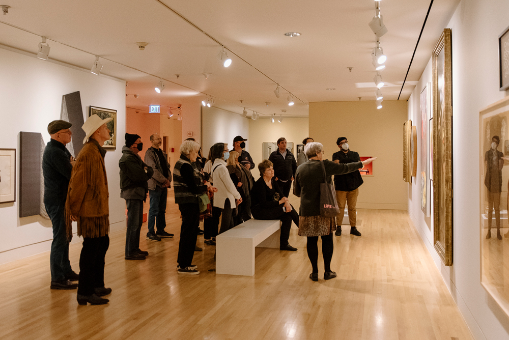 Photograph of a large tour group in the "THE THIRD, MEANING" exhibition