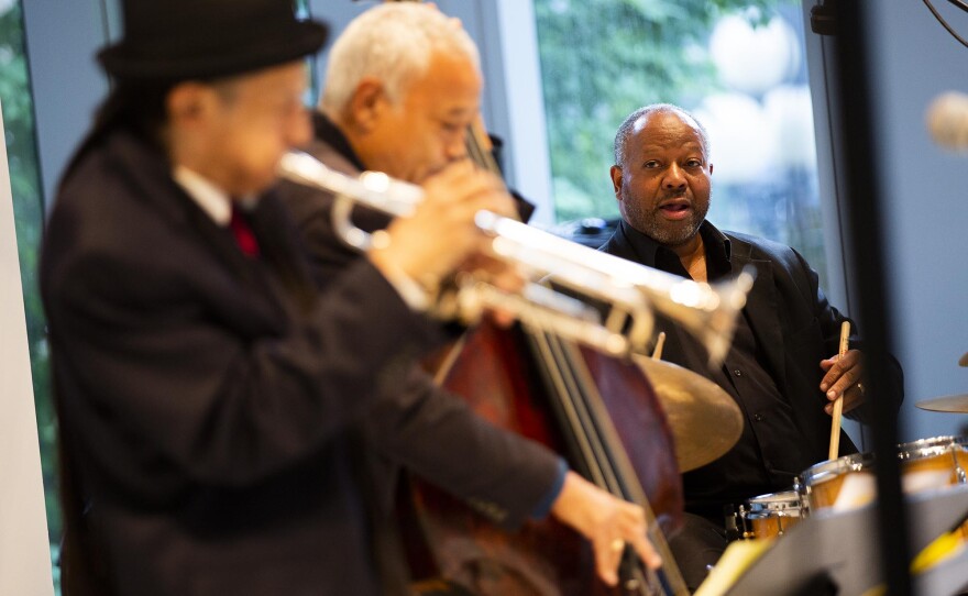 A group of three musicians performing during a concert
