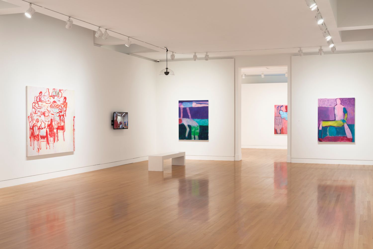 Museum gallery with four artworks and white walls