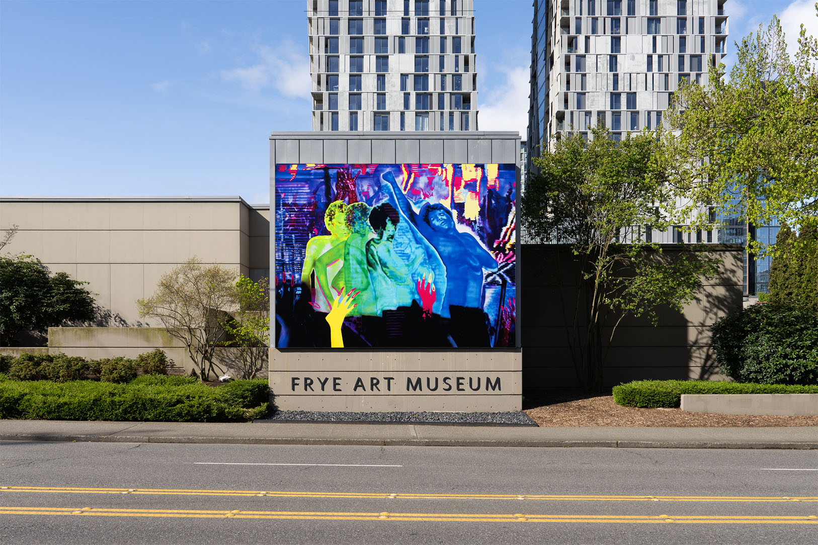 A large, colorful artwork installed on the exterior of a building above the text 'Frye Art Museum'