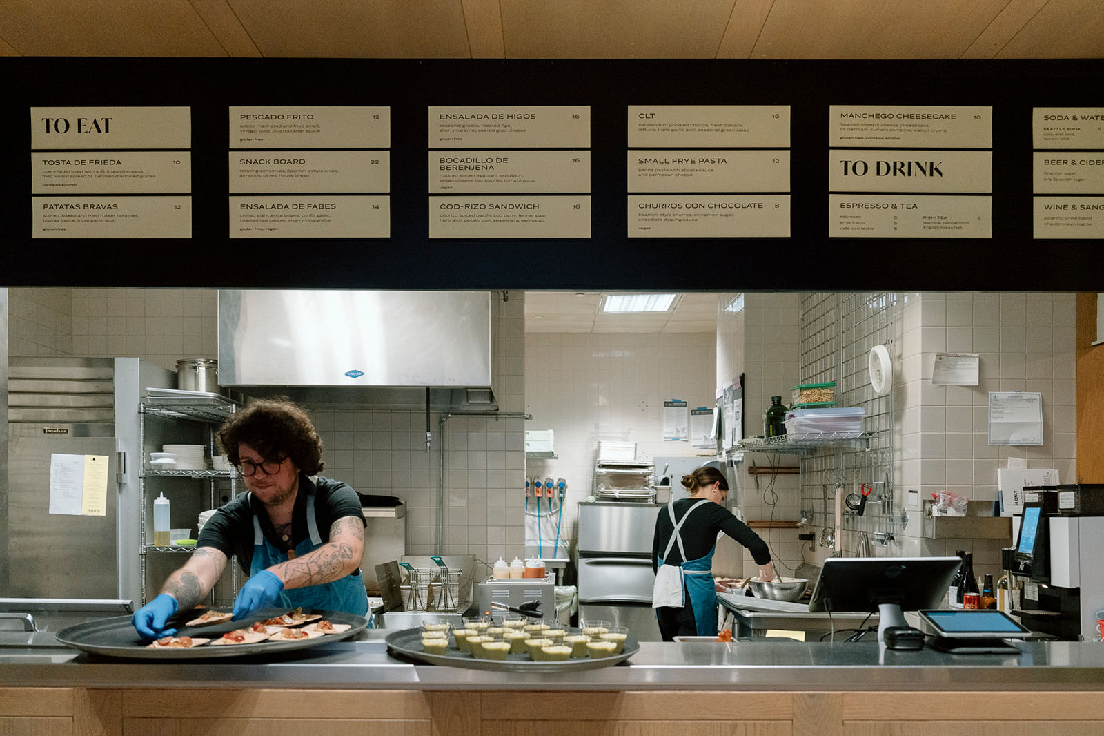 People preparing platters of food at the Frye Art Museum cafe