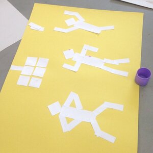 Student lay out figures in motion before gluing them down. Photo: Lynn Chou