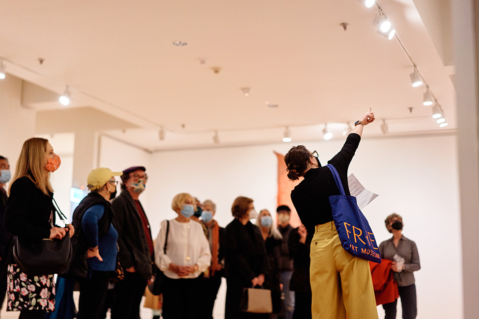 A Frye guide points out a feature of an out-of-frame artwork