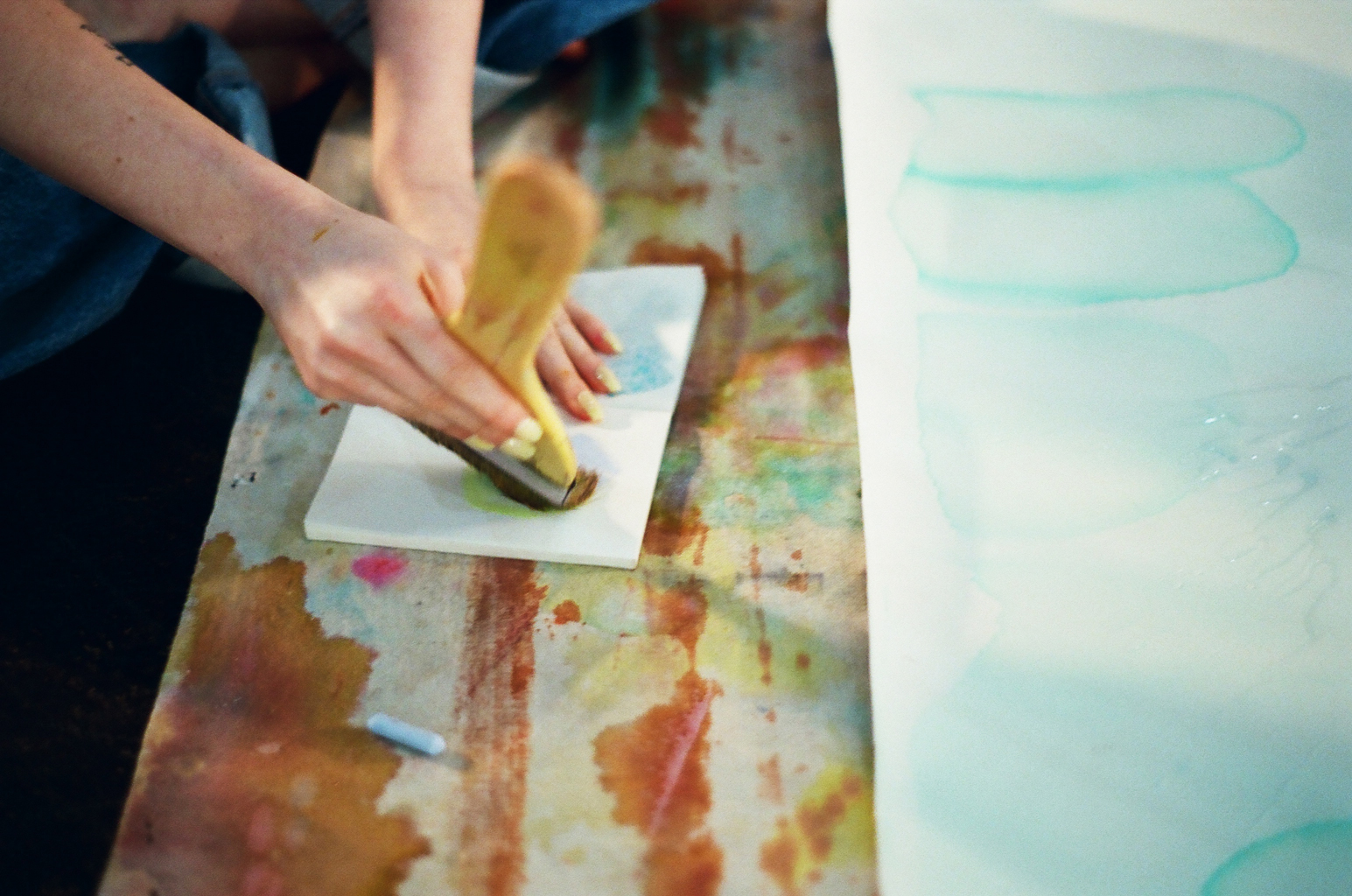 Photo of Lydia Jewel Gerard's hands holding a large brush