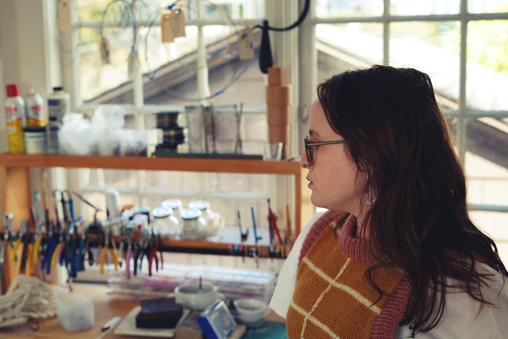Photo of Devon Simpson in front of her jewelry making tools