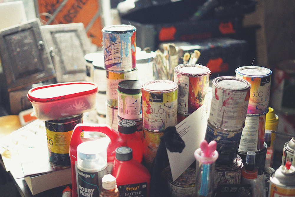 Art supplies stacked on a table 