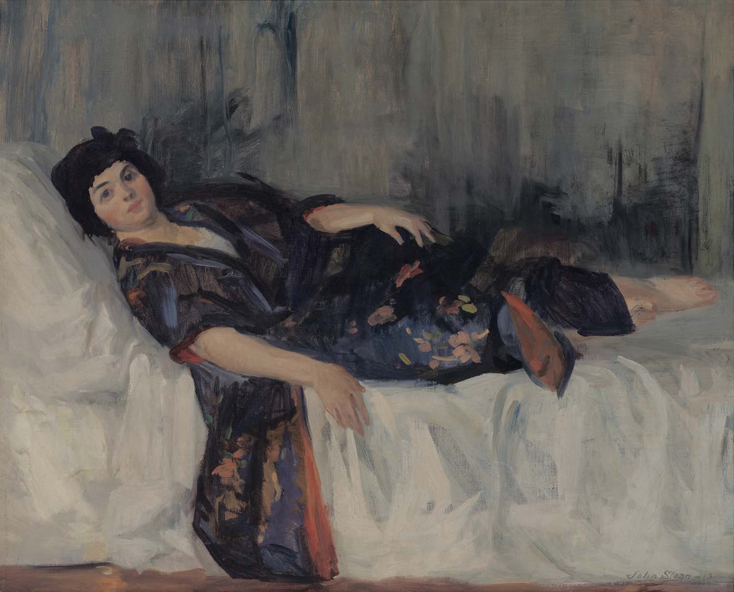 A woman lounging on a bed wearing a blue kimono