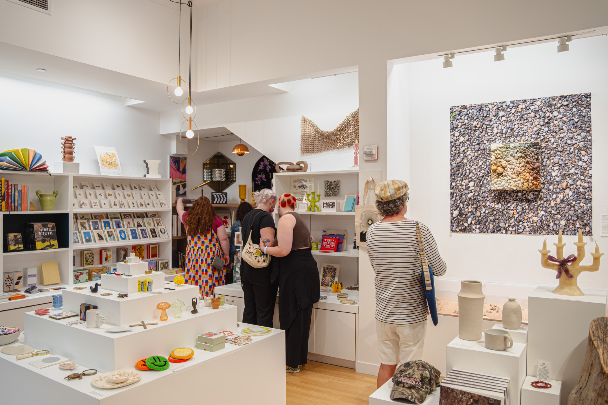 People shopping in a bright, well stocked museum store