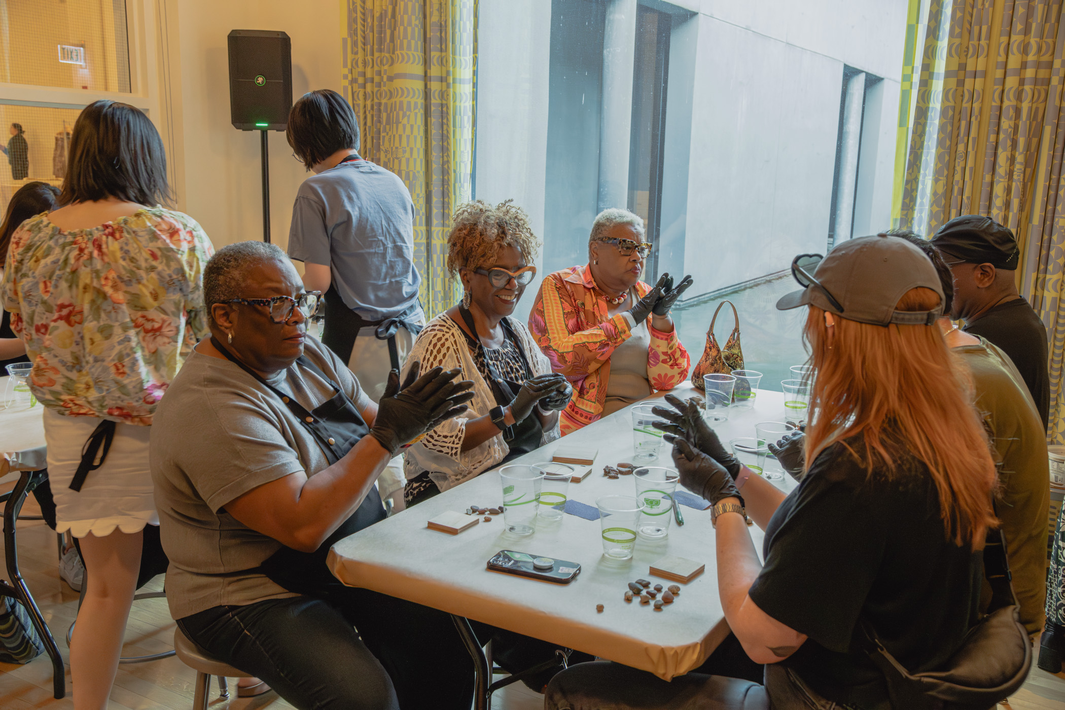 People engaged in an art activity seated at a table