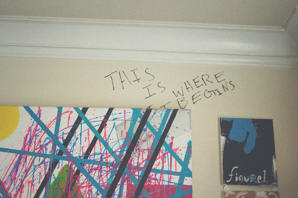 The crown molding of an apartment wall with artworks and handwriting 
