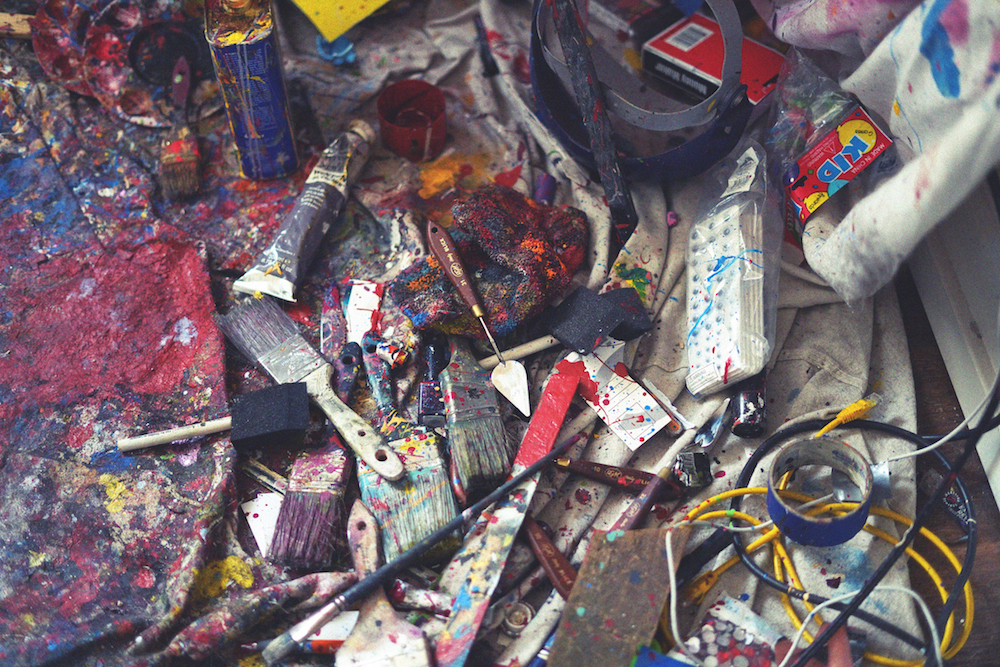 art supplies scattered on a studio floor 