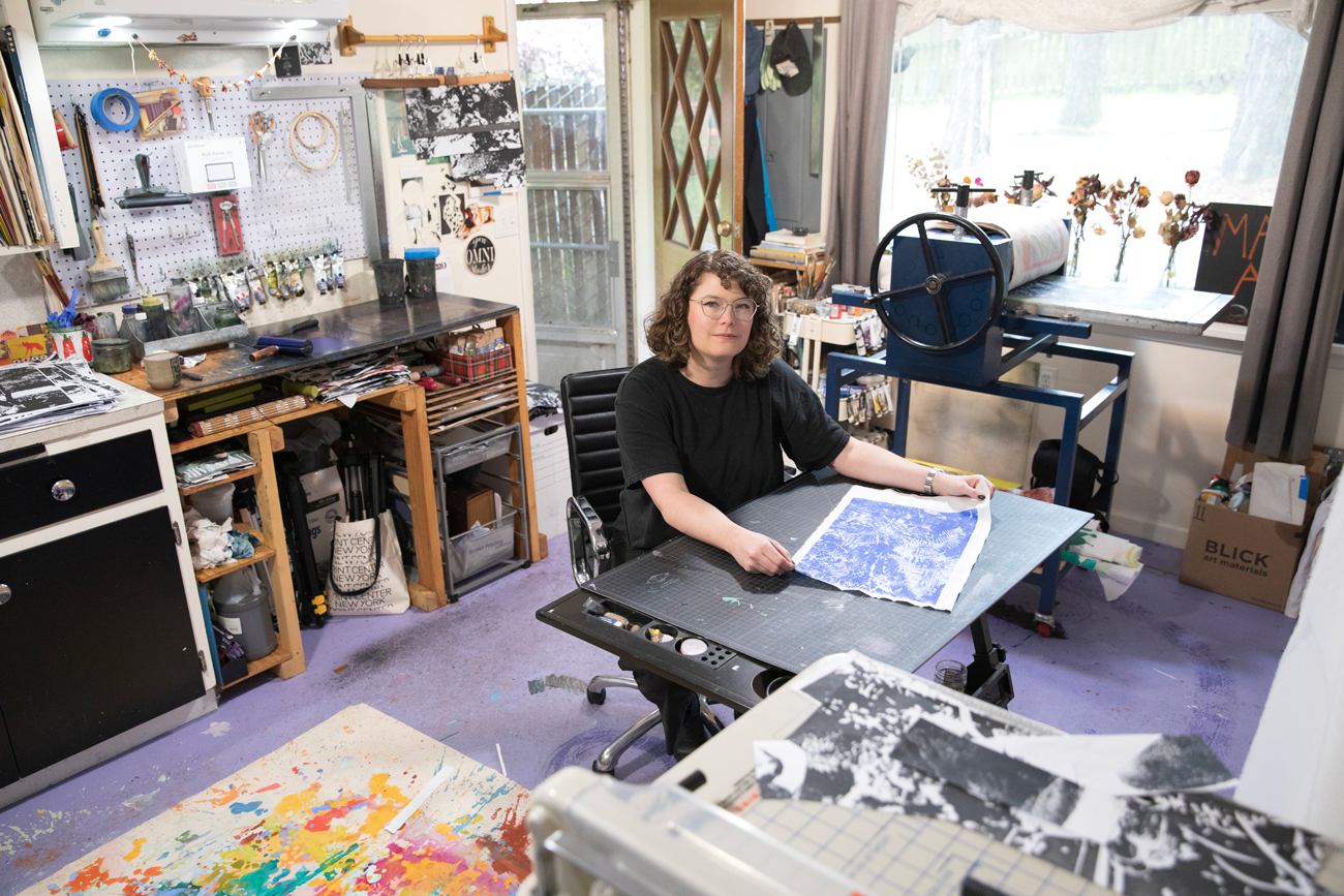 Photo of Shannon Bodrogi sitting in their studio