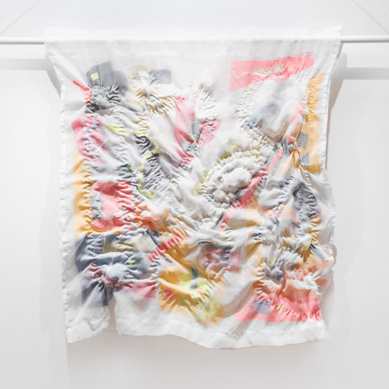 Photo of a sheer and colorful quilted artwork