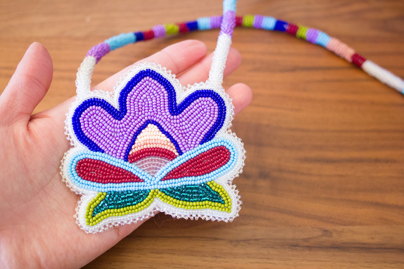 Photo of a beaded flower being held in one hand