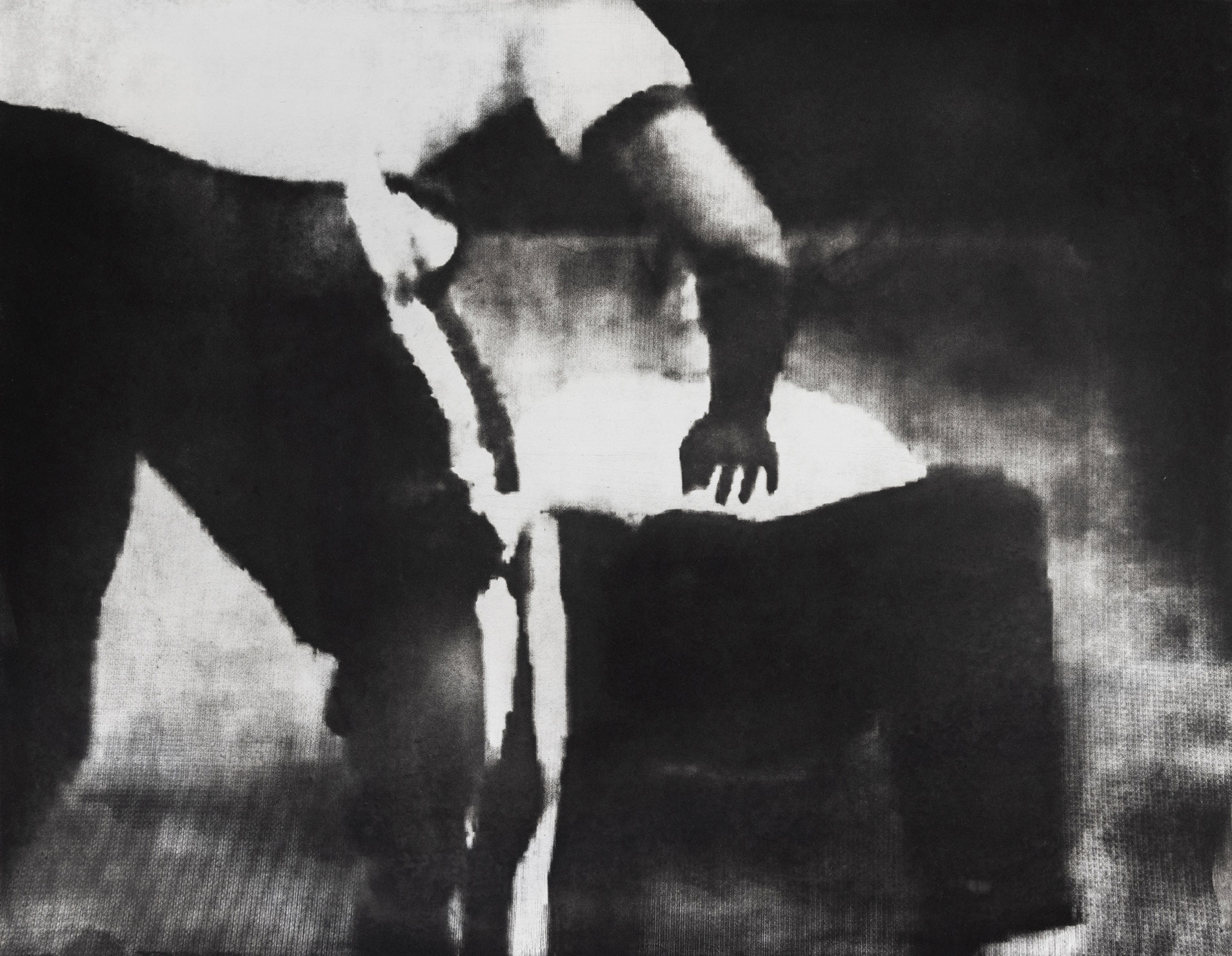 Black and white photo of a person lying on the ground and another figure standing over them