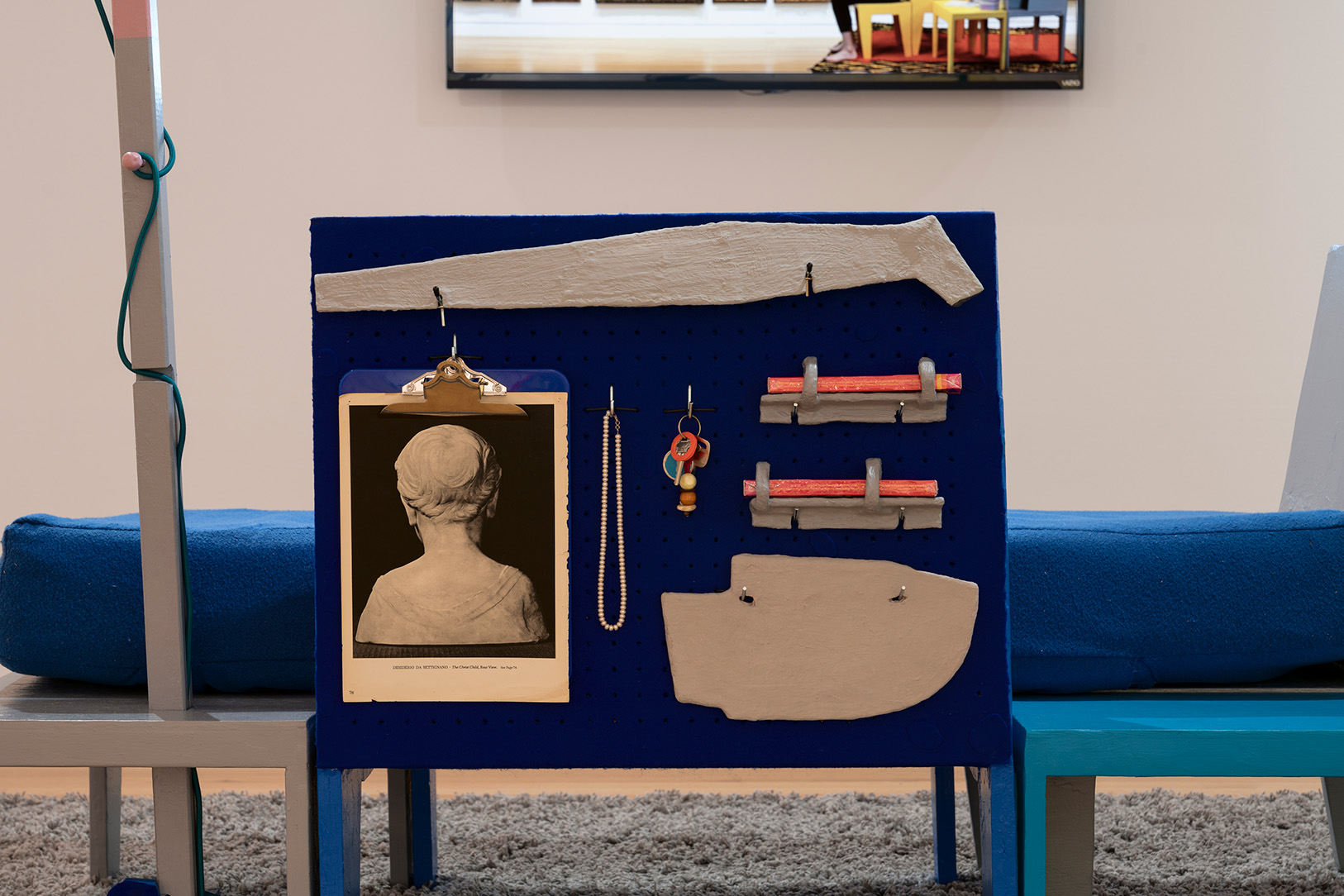 A close up image of a piece of furniture incorporating a daybed and small household items