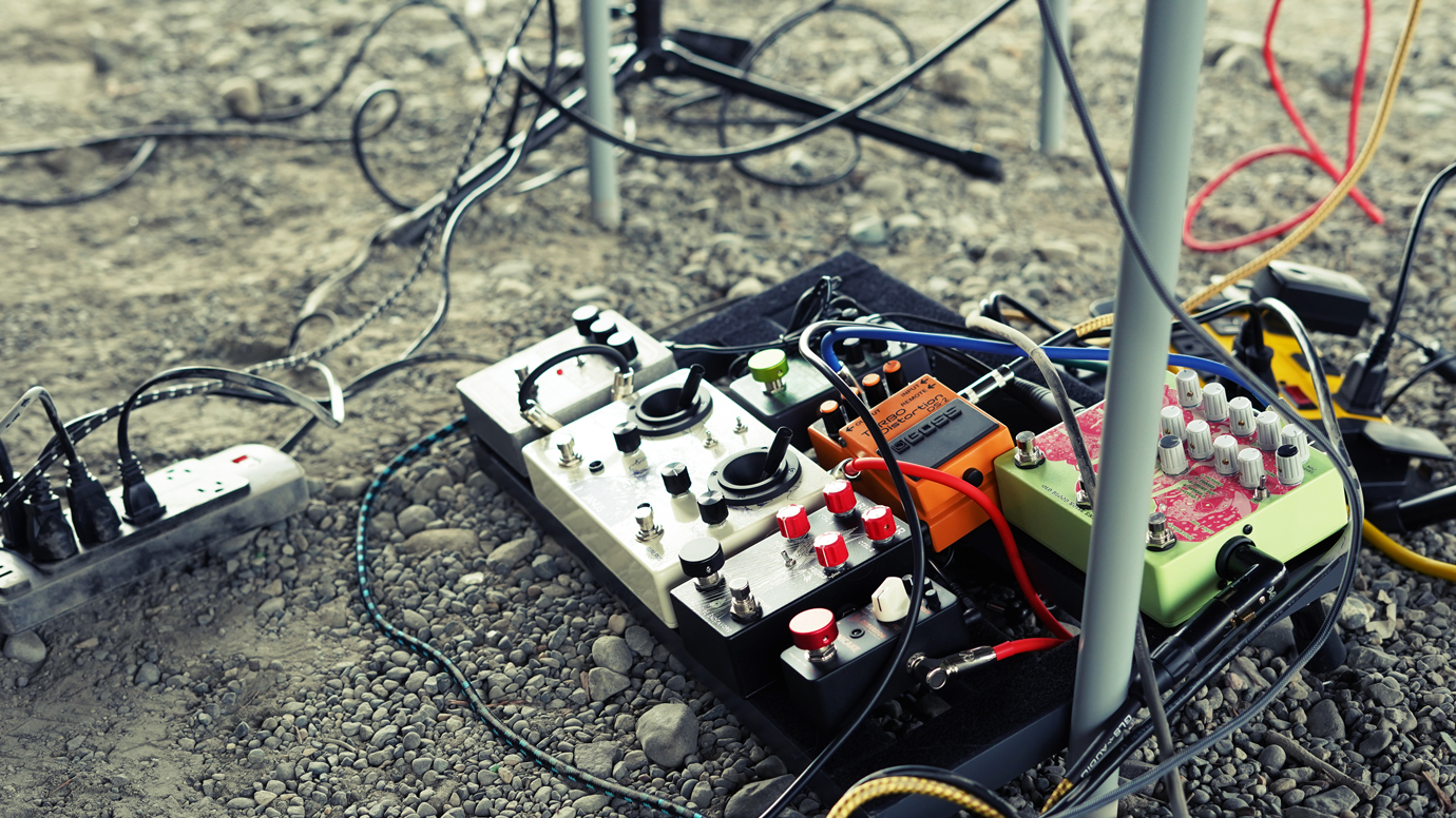 Photo of a pedal board on the ground outside