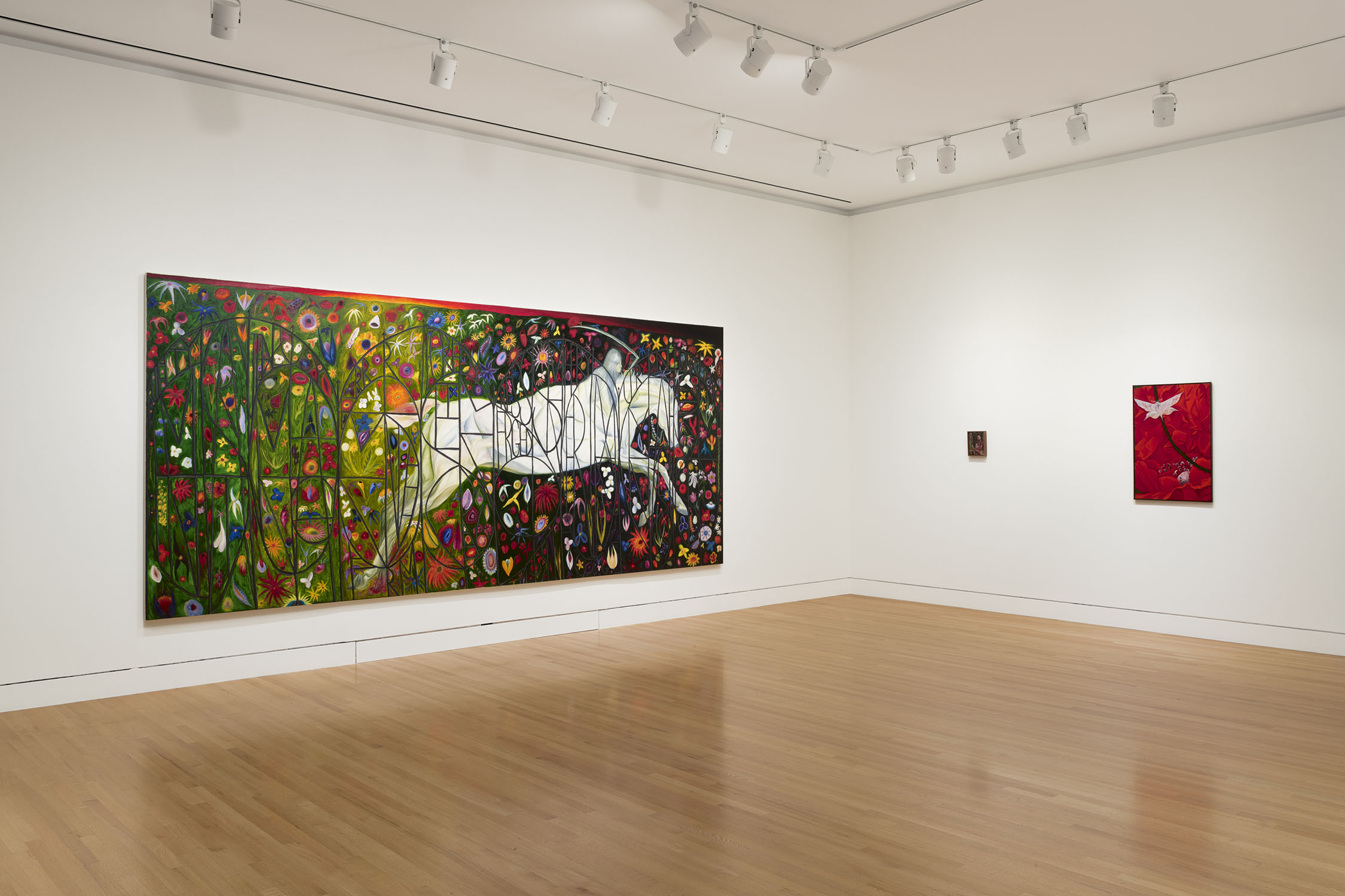 Museum gallery with three artworks and white walls