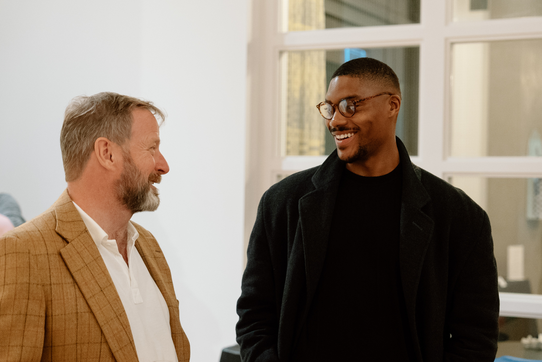 Two people chatting and smiling in an well lit space
