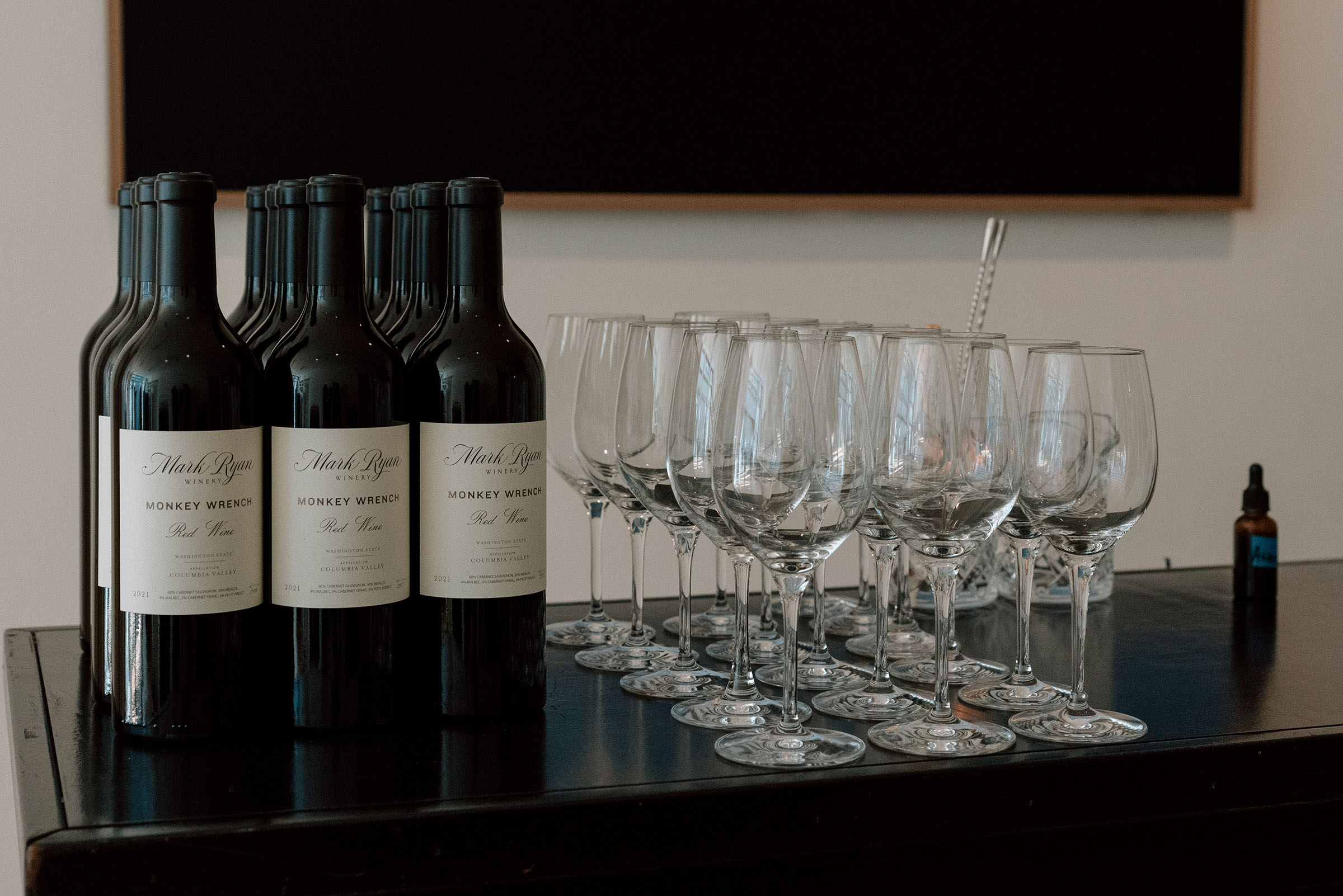 Bottles of wine and clean wine glasses on a bar
