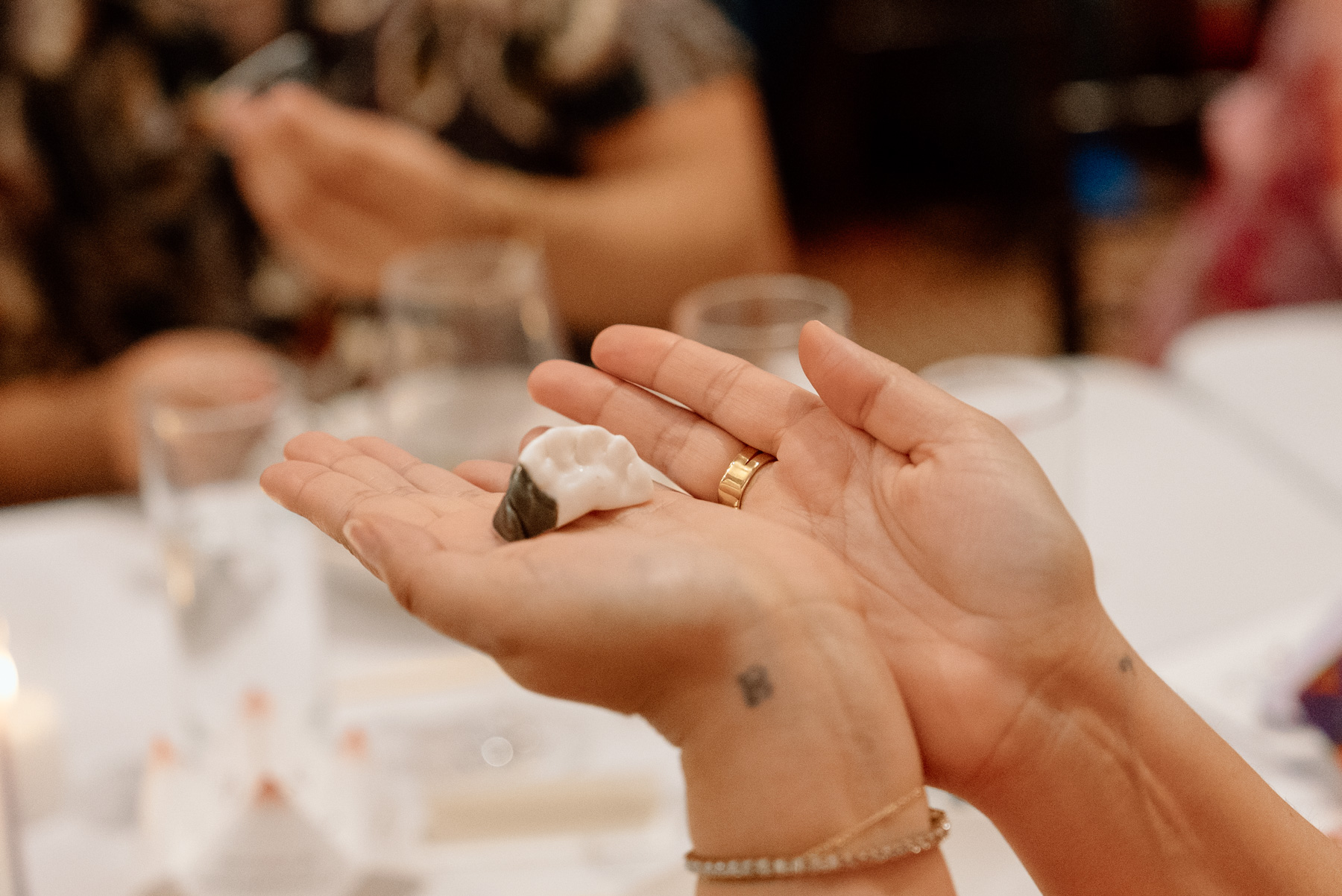 Hands holding a ceramic dumpling