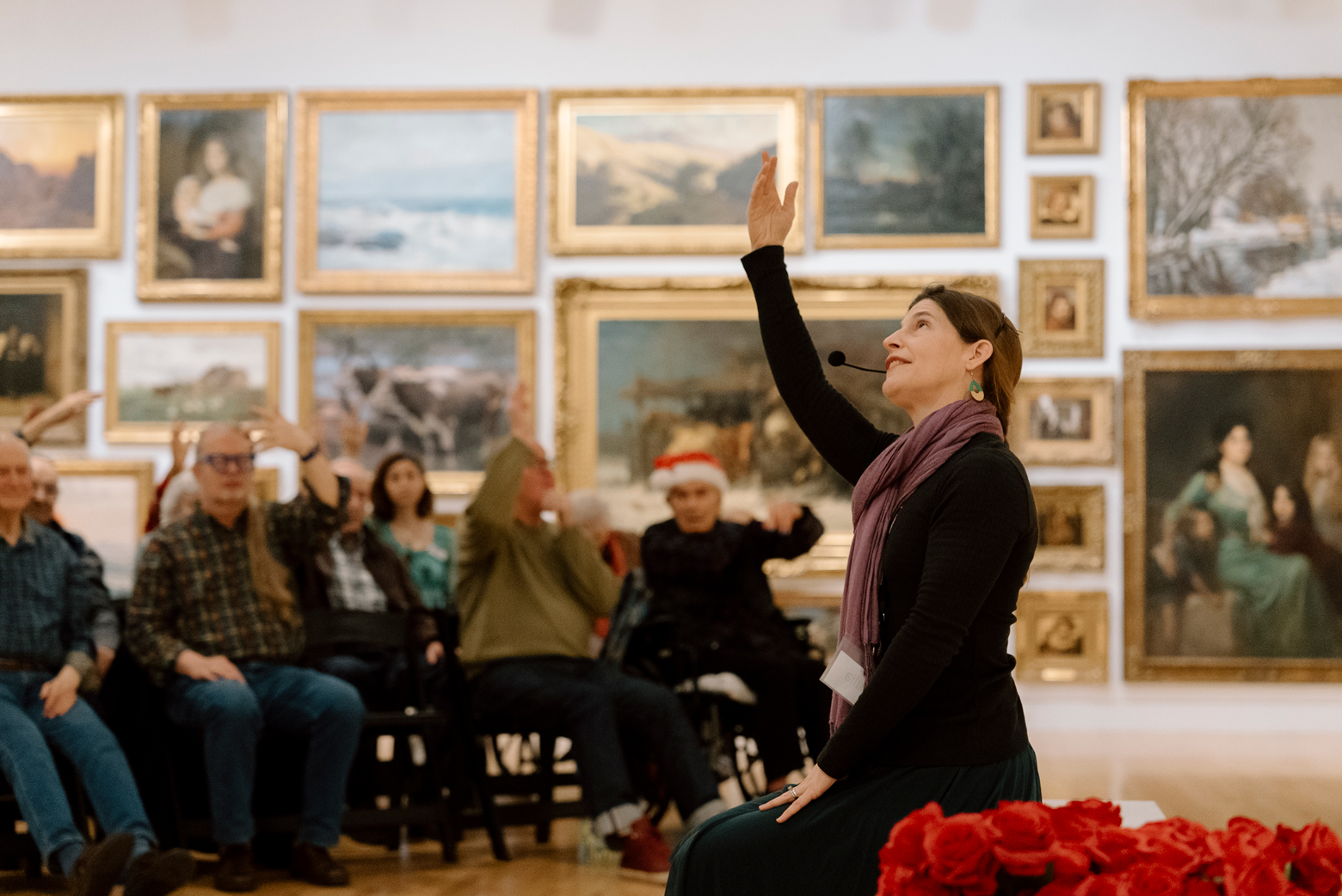Dr. Julia Becke does seated movement with a group of participants in the Frye Salon