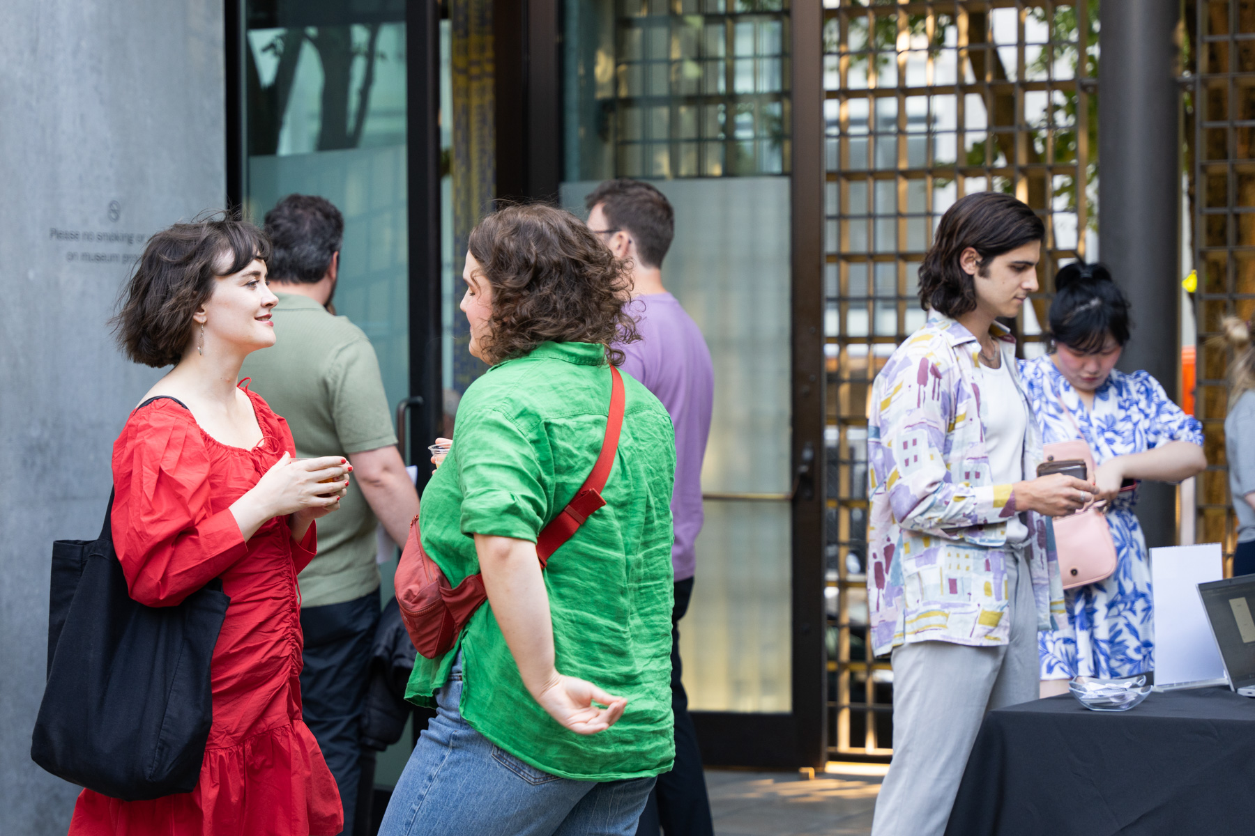 People chatting and drinking in the Frye courtyard