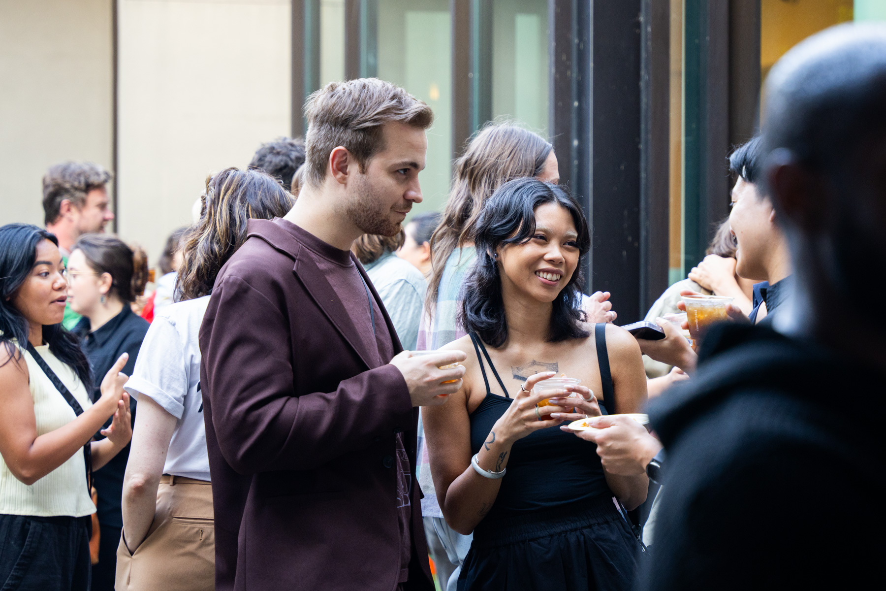 People drinking and chatting in the Frye Courtyard