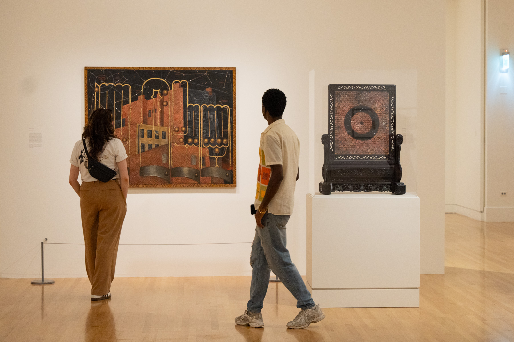 People walking through a Frye gallery and looking at art