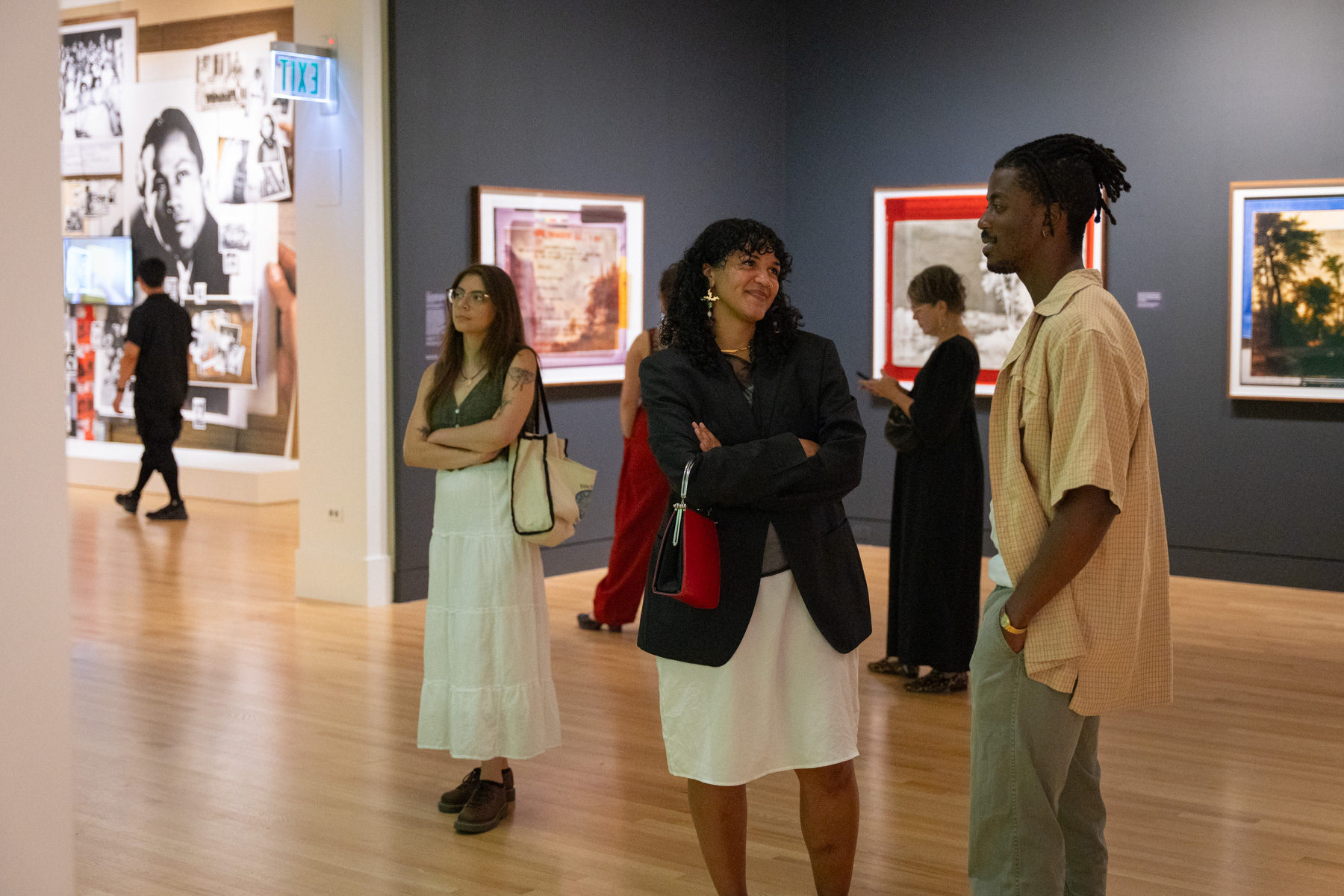 People chatting in a gallery while looking at art
