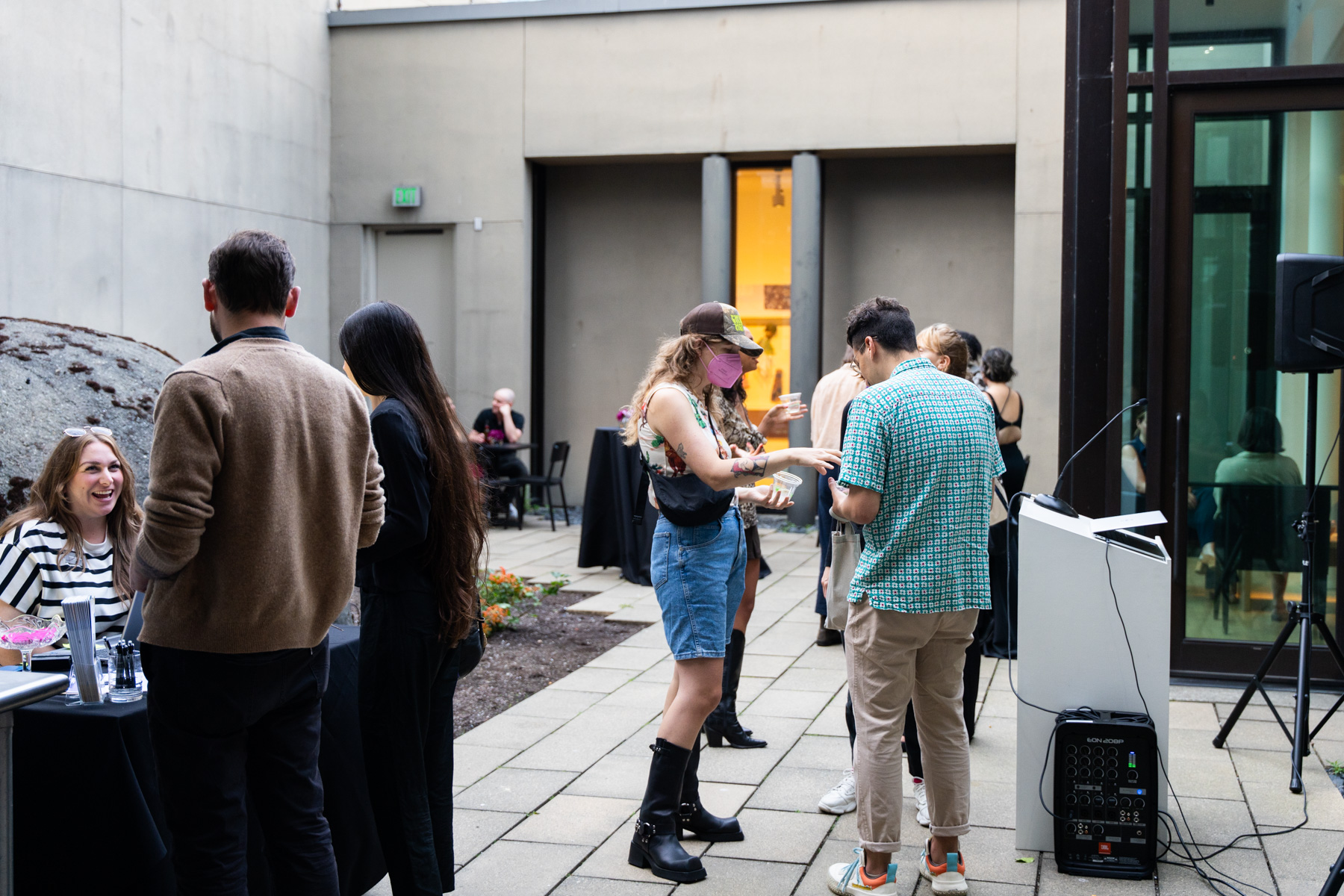People chatting in groups in the Frye courtyard