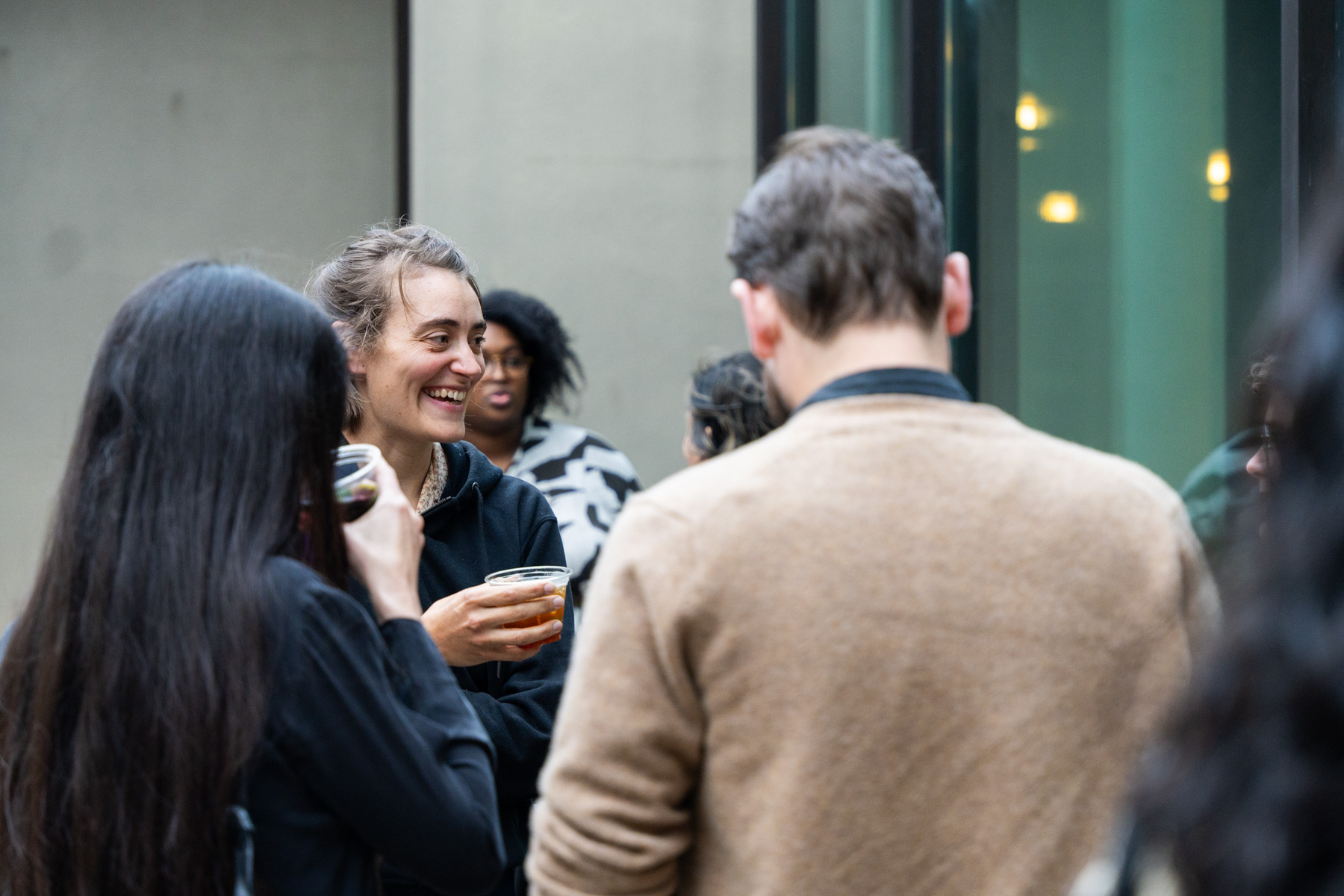 A group of people chatting in the Frye courtyard