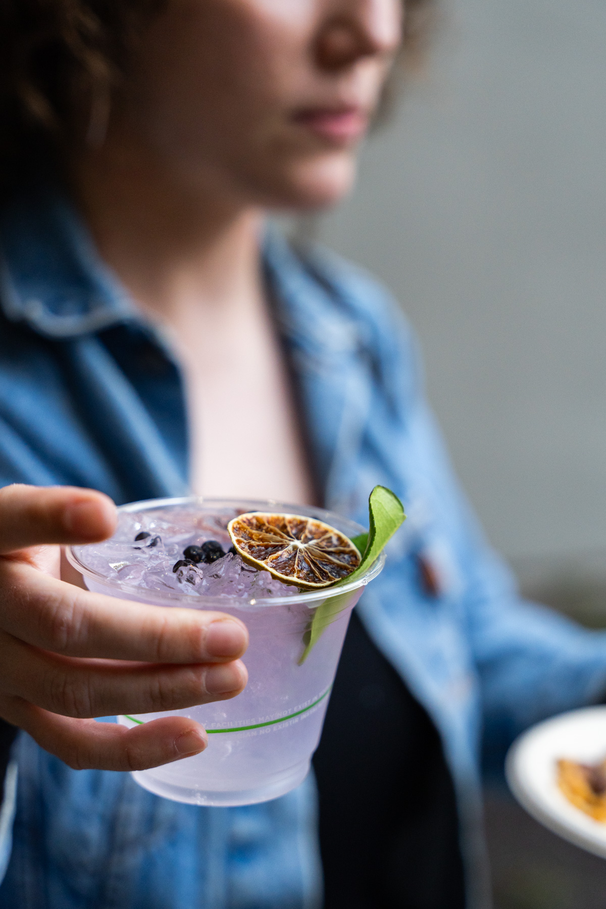 A light purple drink in a person's hand