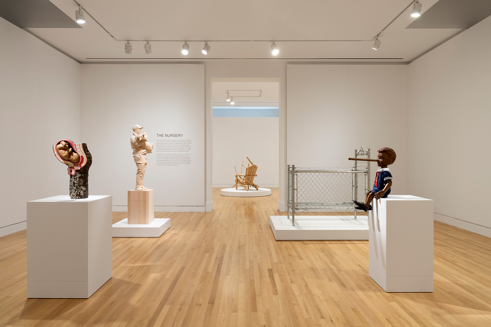 A room with four sculptural artworks in each corner on pedestals