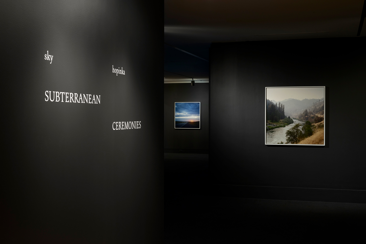 Installation view of the exhibition title wall and two works in Sky Hopinka: Subterranean Ceremonies at the Frye Art Museum