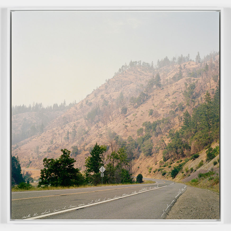 A photo of a road and hazy hillside