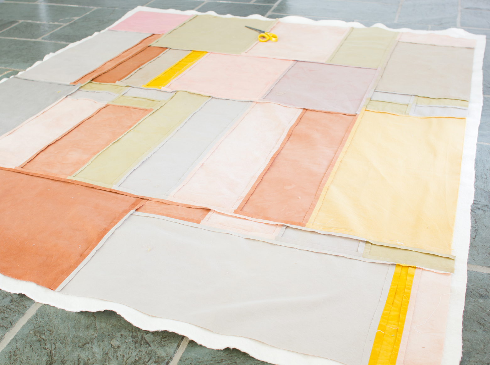 Photo of a quilt laid out on the ground