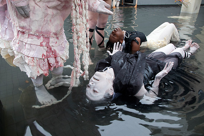 Performers in the Frye Art Museum reflecting pool