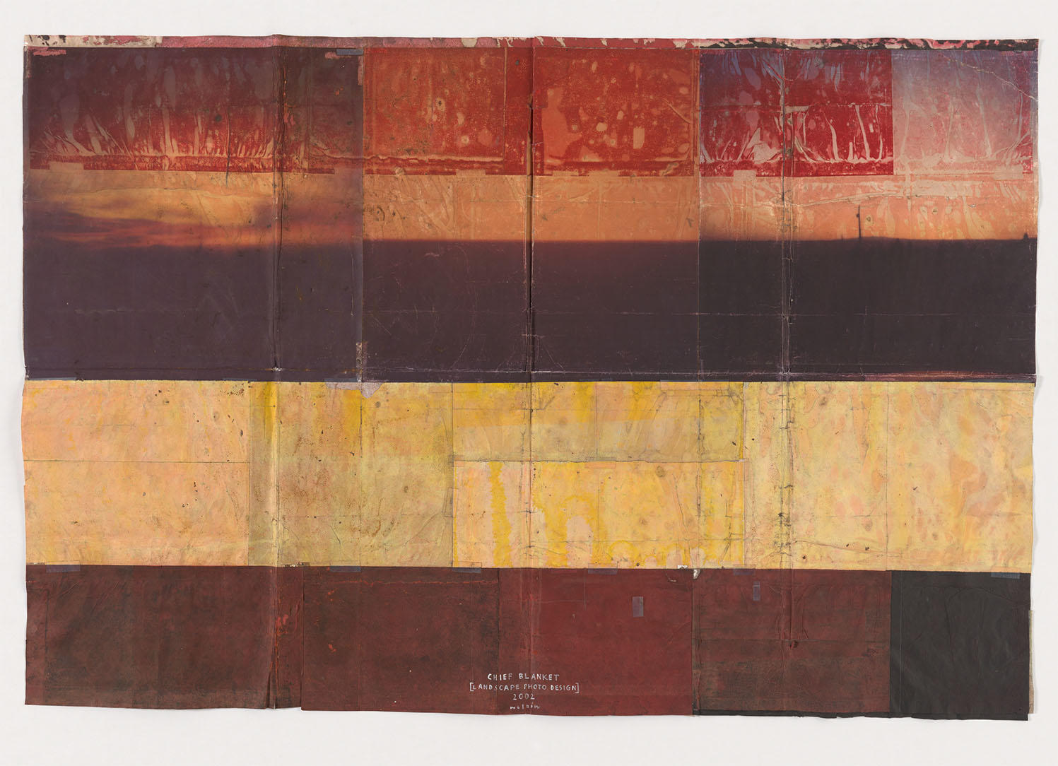 A tactile blanket sculpture in yellow and orange gradients
