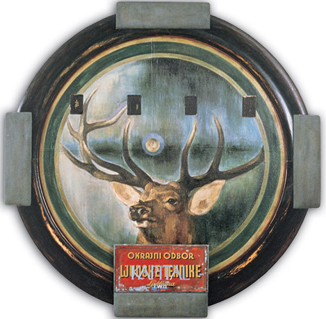 A painting of a deer in a circular frame