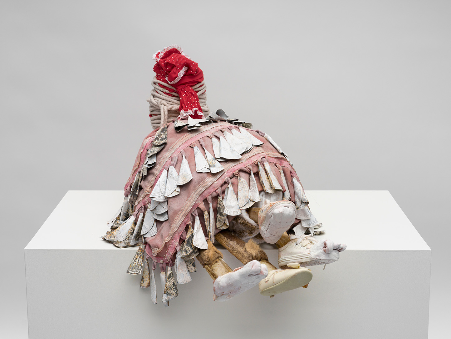 A sculptural figure made from cotton cloth, twine, clay, deer legs, and more by Natalie Ball