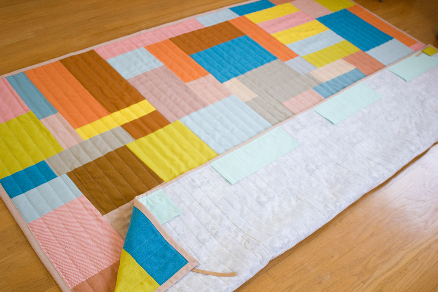 Photo of an in-process quilt laid out on the floor