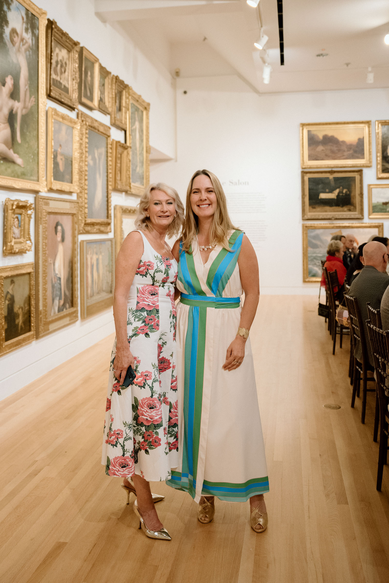 Two women standing and smiling at the camera