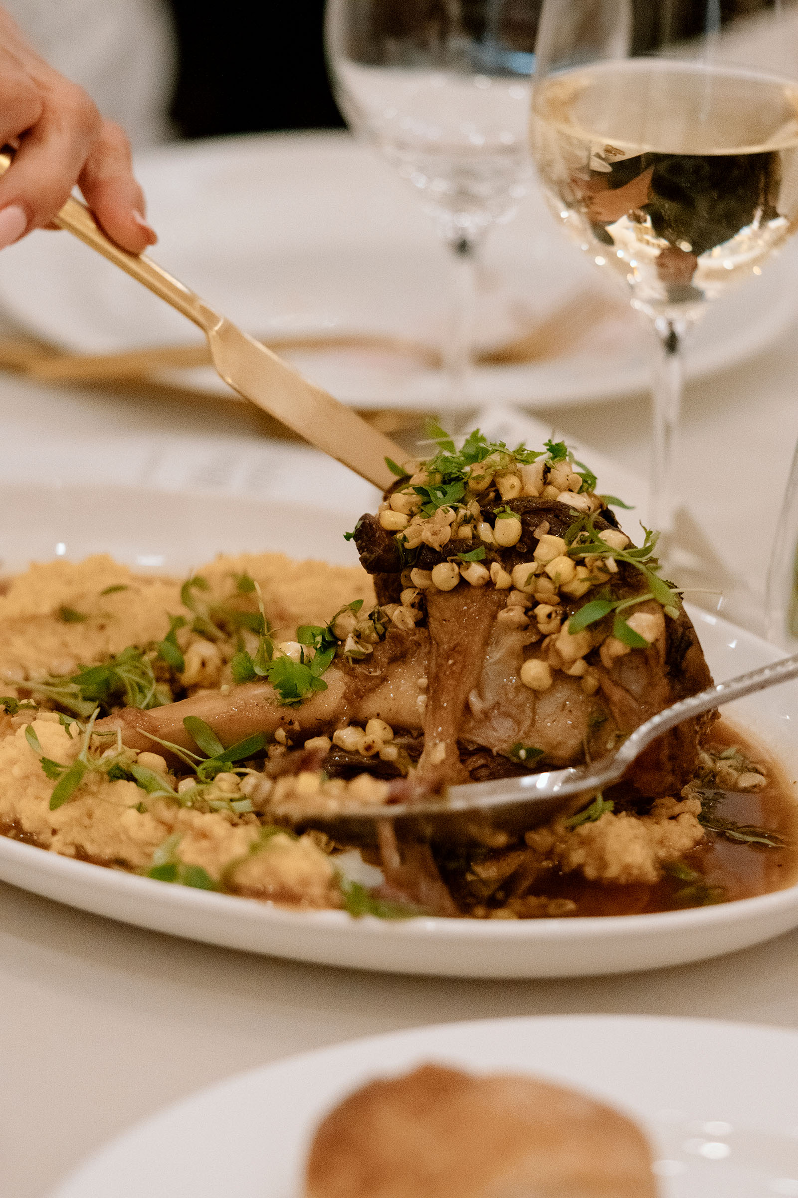 A large piece of meat on a dish being served family style