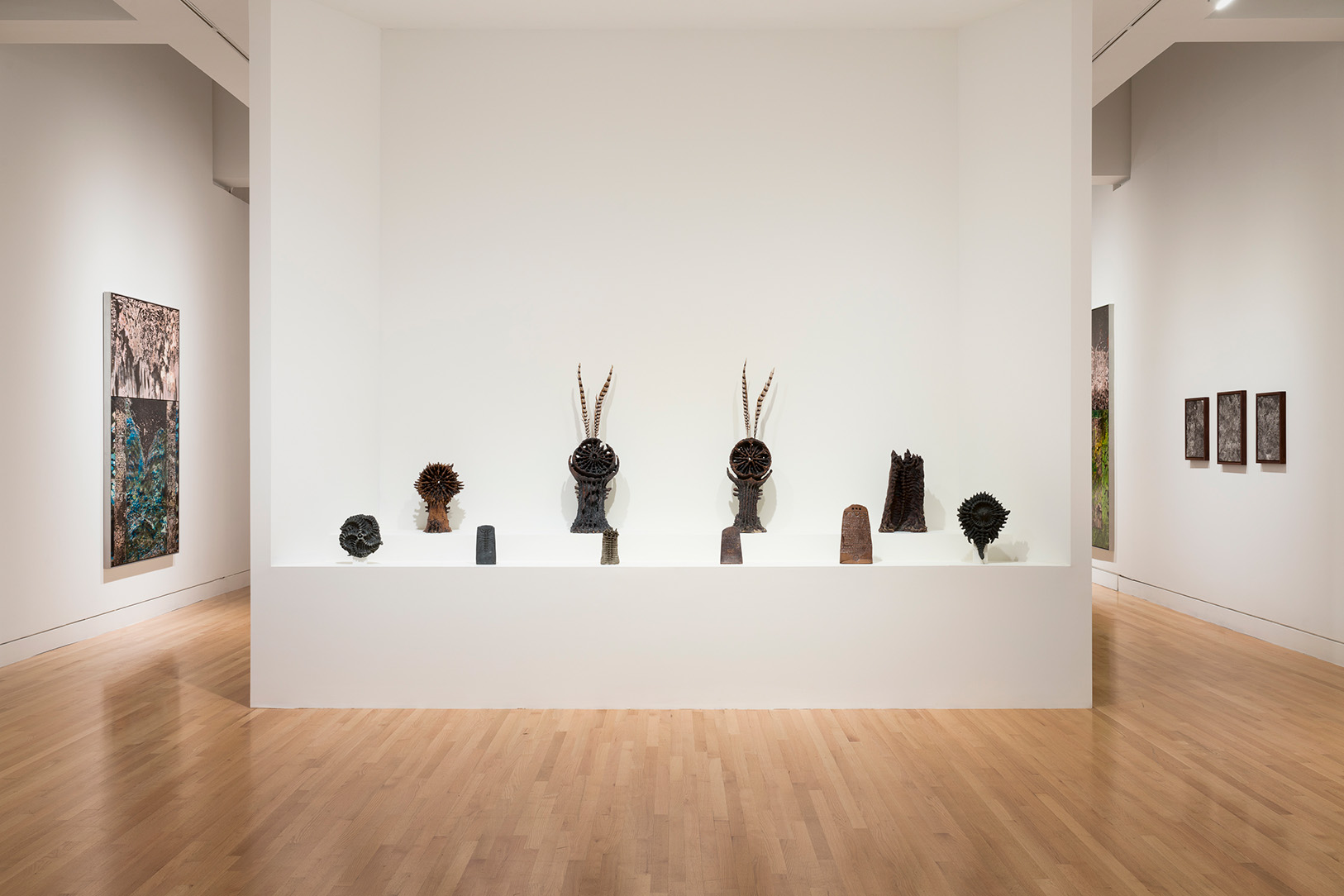 A group of ceramics on two shelves in a museum gallery