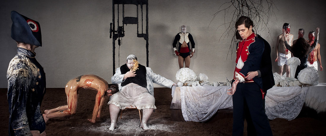 A surreal tableau of people in early 19th century costume and various states of undress