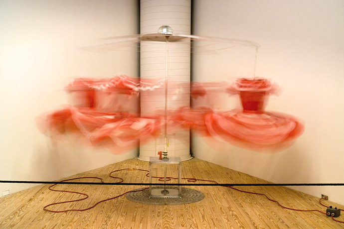 A long exposure photo of a dress being moved by machinery