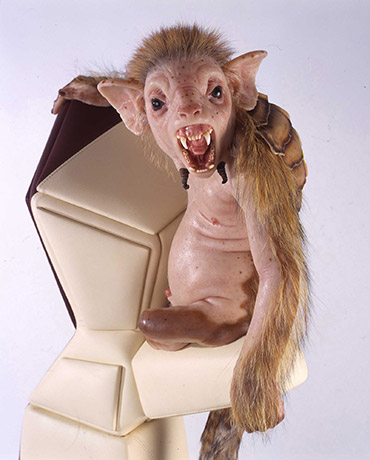 A realistic hybrid monkey-like animal sculpture