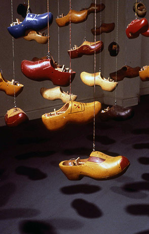 Clogs in different colors hanging from wires
